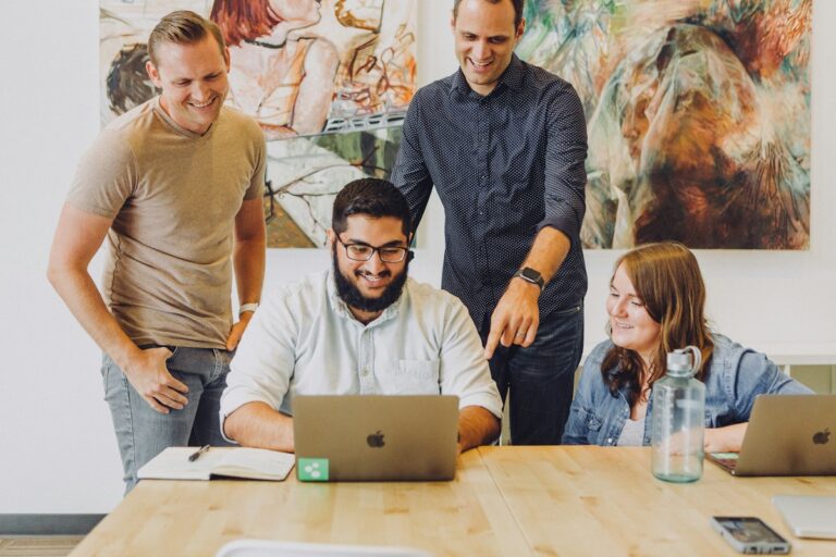Employer Branding: Lachendes Team bei der gemeinsamen Arbeit im Büro